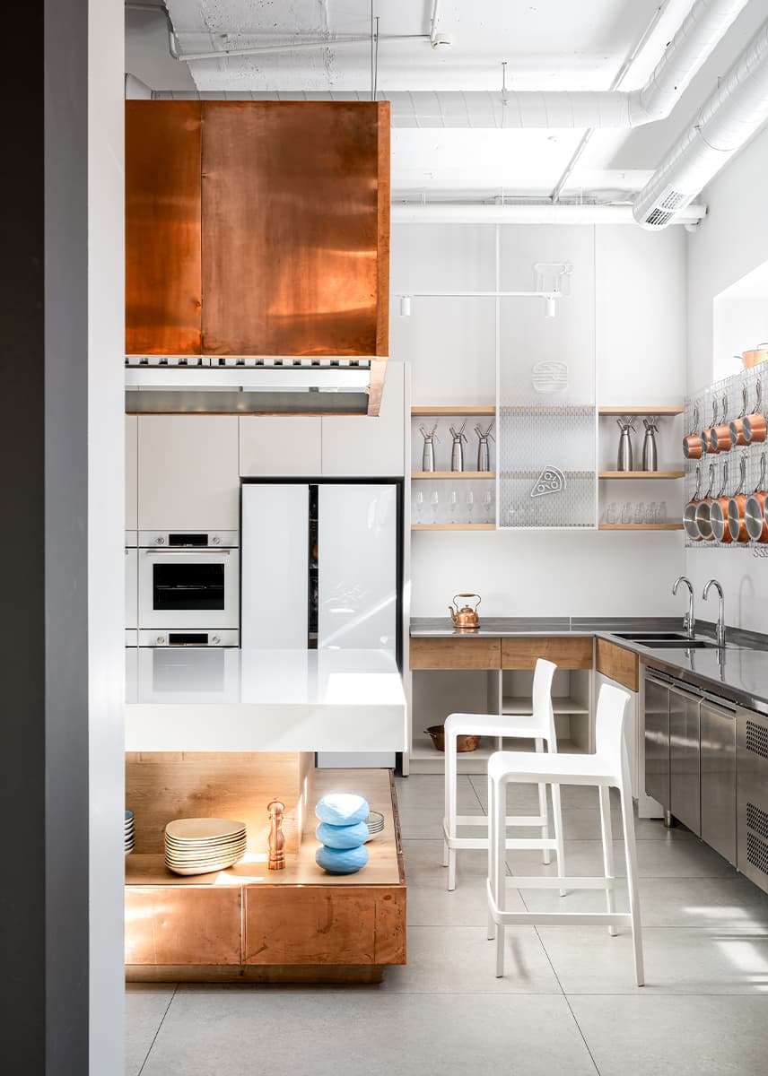 Акцентные медные панели и светильник из сетки в интерьере кулинарной студии — проект Алины Воробьевой